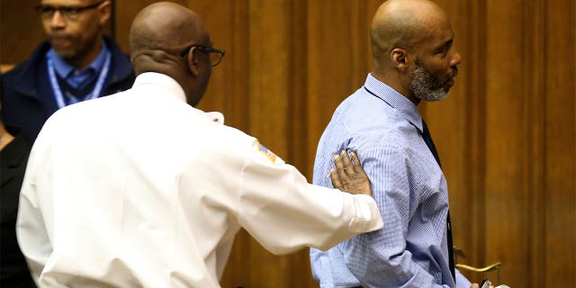 Lamar Johnson gets a congratulatory pat on the shoulder from St. Louis Sherriif Vernon Betts on Tuesday, Feb. 14, 2023.