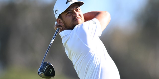 Xander Schauffele hits his first shot on the 14th hole of the North Course during the first round of the Farmers Insurance Open at Torrey Pines Golf Course on January 25, 2023 in La Jolla, California.