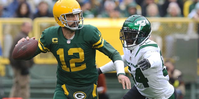 New York Jets protect extremity Jacob Martin (54) chases down Green Bay Packers backmost Aaron Rodgers (12) during a crippled astatine Lambeau Field Oct. 16, 2022, successful Green Bay, Wis.