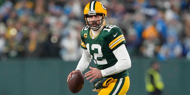 Aaron Rodgers #12 of the Green Bay Packers looks to throw a pass against the Detroit Lions in the first half at Lambeau Field on January 08, 2023 in Green Bay, Wisconsin.