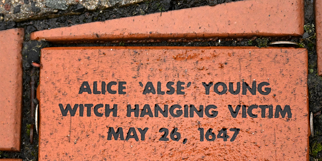 In this Tuesday, Jan. 24, 2023 photo, a brick memorializing Alice 'Alse' Young is placed in a town Heritage Bricks installation in Windsor, Conn. Young was the first person on record to be executed in the 13 colonies for witchcraft.