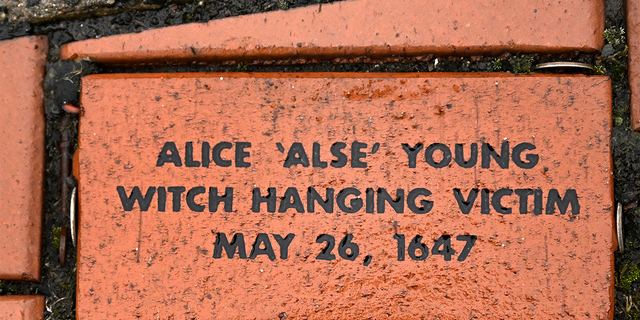In this Tuesday, Jan. 24, 2023 photo, a brick memorializing Alice 'Alse' Young is placed in a town Heritage Bricks installation in Windsor, Conn. Young was the first person on record to be executed in the 13 colonies for witchcraft.