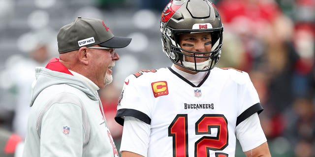 Tom Brady (12) of the Tampa Bay Buccaneers and head coach Bruce Arians speak during warmups before a game against the New York Jets at MetLife Stadium on January 2, 2022 in East Rutherford, NJ 