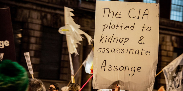 A protester holds a placard during the Julian Assange procession in London to protest against his continued imprisonment. 