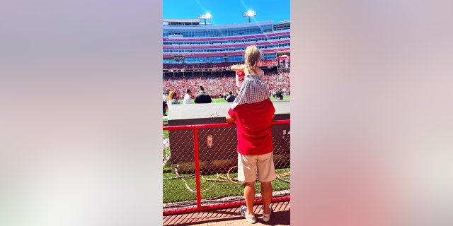 Austyn Woolverton, age five, enjoys watching Huskers football with her grandfather, who is a huge fan of the team.