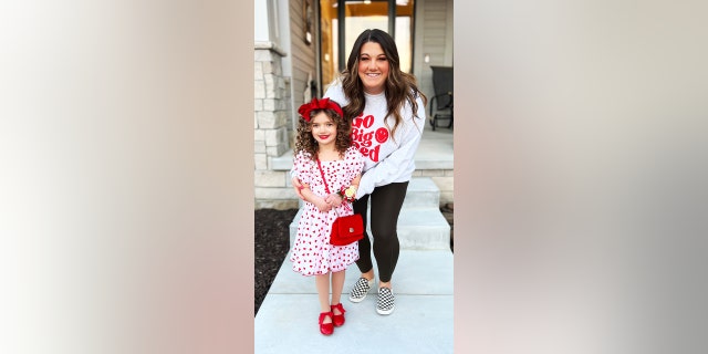 Kelsey Woolverton helped her daughter Austyn get ready by curling her hair and even putting red lipstick on.