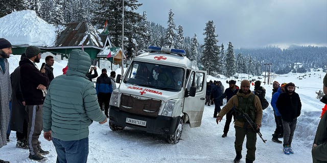 An ambulance leaves with the bodies of two foreign skiers who were killed in an avalanche in Indian-controlled Kashmir, on Feb. 1, 2023.
