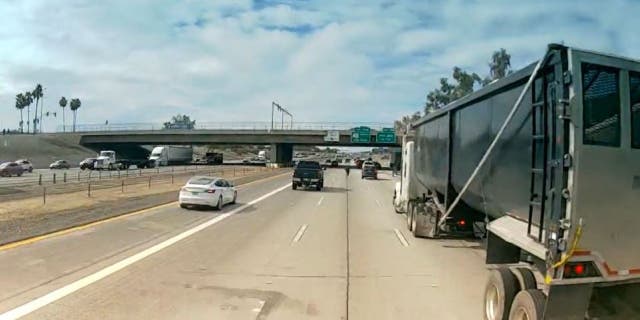 An unidentified Arizona man narrowly missed being hit by trucks as he crossed Interstate 10.