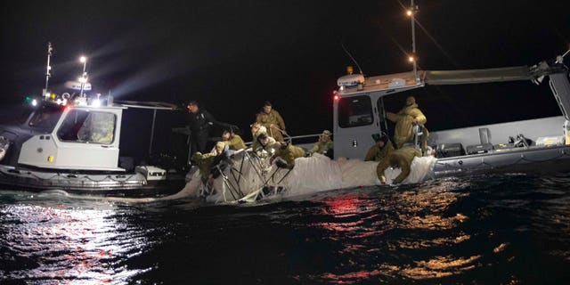 U.S. forces haul debris from China's surveillance balloon onto a boat off the coast of South Carolina.