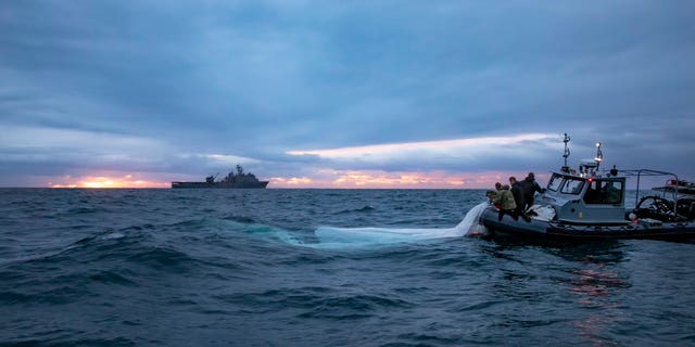 U.S. forces pull pieces of China's surveillance balloon out of the ocean.