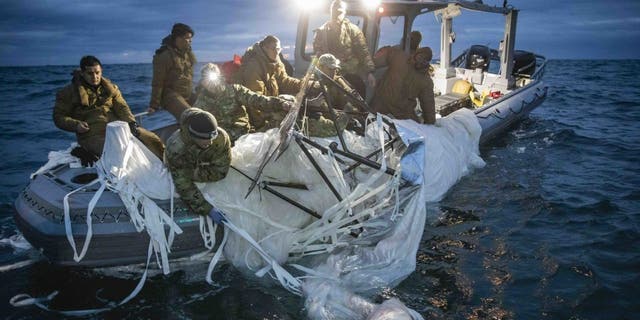 Sailors assigned to Explosive Ordnance Disposal Group 2 recover a high-altitude surveillance balloon off the coast of Myrtle Beach, South Carolina, Feb. 5, 2023.