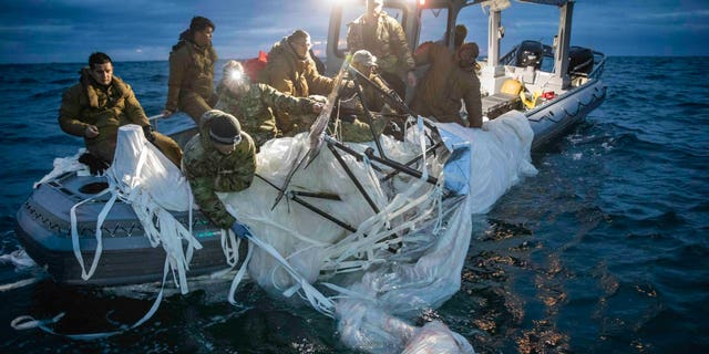 U.S. forces haul debris from China's surveillance balloon onto a boat off the coast of South Carolina.