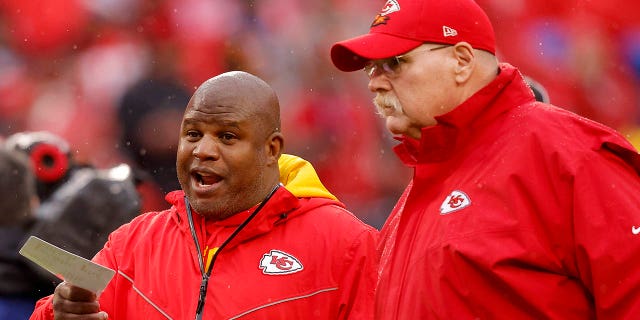 Eric Bieniemy speaks with Chiefs head coach Andy Reid before the AFC divisional playoff game against the Jacksonville Jaguars at Arrowhead Stadium on January 21, 2023 in Kansas City, Missouri.