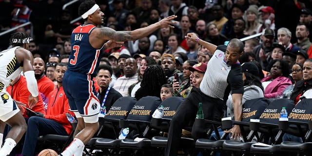 Bradley Beal #3 of the Washington Wizards crashes into referee John Butler #30 in the third quarter against the Indiana Pacers at Capital One Arena on February 11, 2023 in Washington, DC.