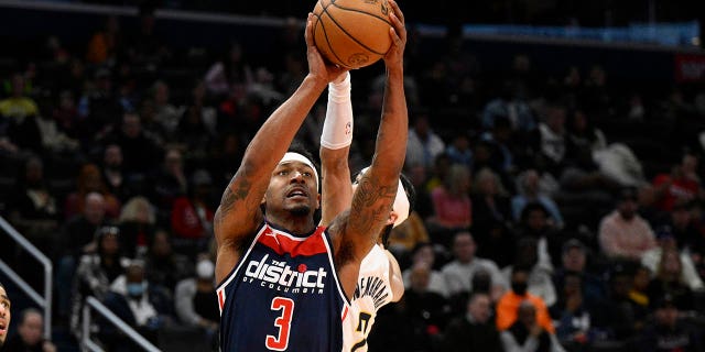 Washington Wizards guard Bradley Beal (3) goes to the basket past Indiana Pacers guard Andrew Nembhard (2) and guard Tyrese Haliburton (0) during the first half of an NBA basketball game Saturday, Feb. 11, 2023, in Washington.