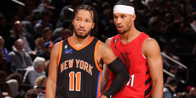 Jalen Brunson, #11 of the New York Knicks, speaks with Josh Hart, #11 of the Portland Trail Blazers, during the game on November 25, 2022 at Madison Square Garden in New York City.