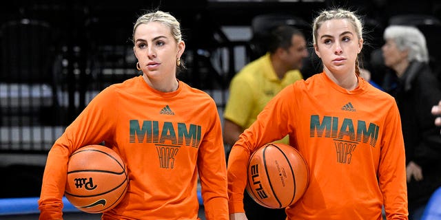 Haley Cavinder, left, and Hanna Cavinder of the Miami Hurricanes warm up before a game against the Pittsburgh Panthers at Petersen Events Center Jan.  1, 2023, in Pittsburgh. 