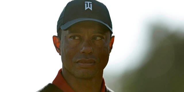 Tiger Woods prepares to present the trophy to Jon Rahm of Spain after he won the Genesis Invitational at Riviera Country Club, Feb. 19, 2023, in Pacific Palisades, California.