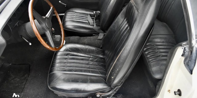 The car's interior is unrestored.
