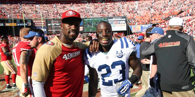 Vernon Davis of the San Francisco 49ers, left, stands with his brother Vontae Davis (23) of the Indianapolis Colts following a game at Candlestick Park Sept. 22, 2013, in San Francisco.