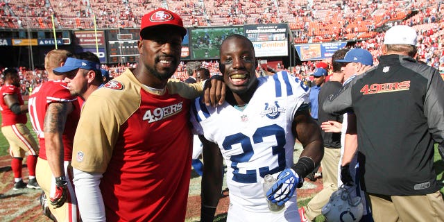 Vernon Davis of the San Francisco 49ers, left, stands with his brother Vontae Davis (23) of the Indianapolis Colts following a game at Candlestick Park Sept. 22, 2013, in San Francisco.