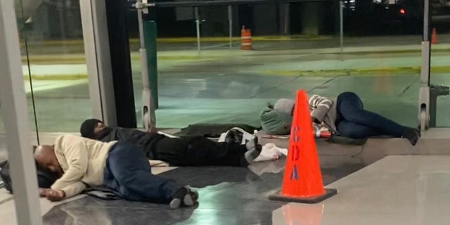 Homeless people sleeping on the floor in Chicago's O'Hare Airport.