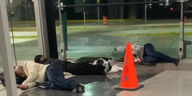 Homeless people sleeping on the floor in Chicago's O'Hare Airport.