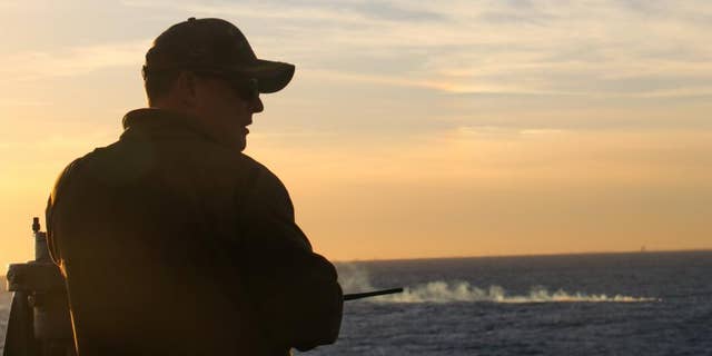 Cmdr. Brad A. Fancher, commanding officer of the USS Carter Hall, observes the debris field where a Chinese surveillance balloon was shot down on Saturday.