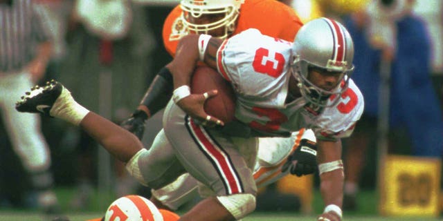 Dimitrious Stanley of Ohio State (3) is tripped up by Jesse Sanders of Tennessee (22) while returning a punt during the first half of the Citrus Bowl.