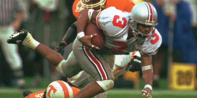Dimitrious Stanley of Ohio State is tripped up by Jesse Sanders of Tennessee while returning a punt during the first half of the Citrus Bowl on Jan. 1, 1996.