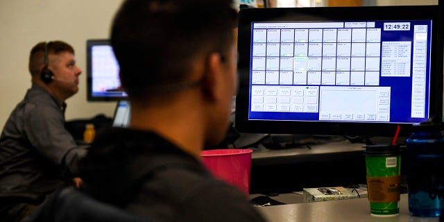 Denver Police dispatcher Raymond Rowland works at his station on Thursday, Nov. 1, 2018. The Denver Police Department is considering encrypting all of its radio channels, meaning the public will not be able to listen in via scanners as field officers communicate with dispatchers at the 911 center.