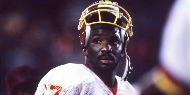 Quarterback Doug Williams of the Washington Redskins stands on the sideline during the third quarter of the Redskins' 42-10 victory over the Denver Broncos in Super Bowl XXII at Jack Murphy Stadium in San Diego.