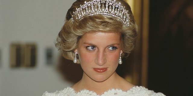 Princess Diana wearing a white dress and a tiara