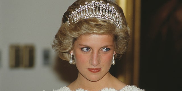 Princess Diana wearing a white dress and a tiara