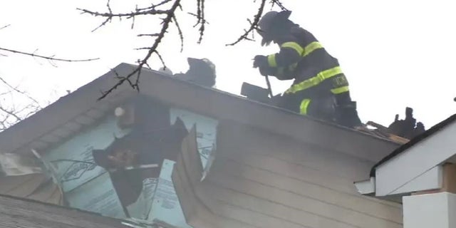 New York City firefighters on the roof of a home of a fire that injured 20 fire personnel Friday. 