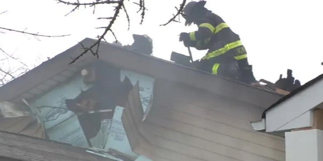 New York City firefighters on the roof of a home of a fire that injured 20 fire personnel Friday. 