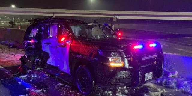 An officer escaped after his patrol vehicle was hit by the trailer of a jack-knifed 