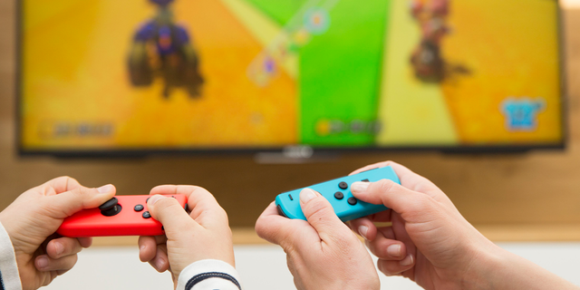Mother and child playing video game.