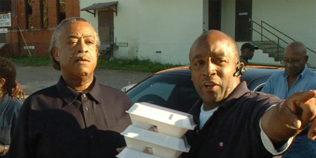 Rev. Al Sharpton and his half-brother Kenneth Glasgow as they hand out holiday meals in 2006.