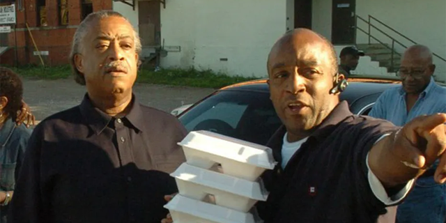 Rev. Al Sharpton and his half-brother Kenneth Glasgow as they hand out holiday meals in 2006.