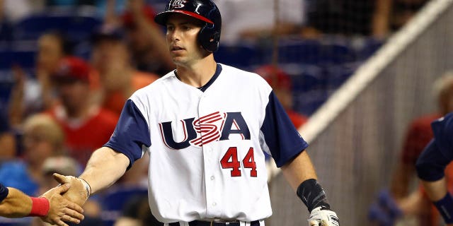 Ian Kinsler of Team USA is greeted by teammate Paul Goldschmidt after scoring a run during Game 6 of Pool C of the 2017 World Baseball Classic against Team Canada March 12, 2017, at Marlins Park in Miami, Fla.