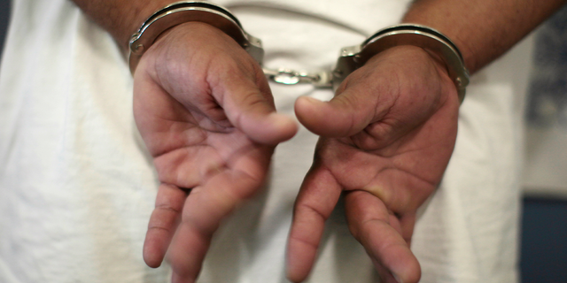 Man in handcuffs.