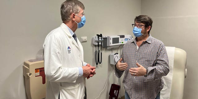 Dr.  John Puskas (left) and patient David Holland undergoing a unique quadruple bypass in November 2022. 