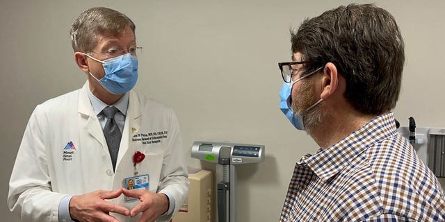 Dr. John Puskas (on left) and patient David Holland. "The [cardiac]<strong> </strong>calcium score is a very objective way of identifying those patients and getting them on the pathway toward treatment before they have a big heart attack," said Dr. Puskas. 