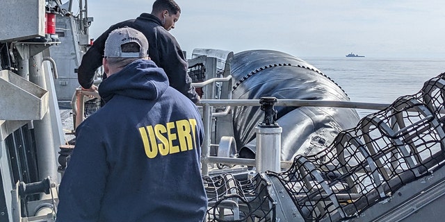 (Off The Coast of South Carolina) – FBI Underwater Search Evidence Response Team (USERT) Members ready equipment to recover material from the ocean floor.