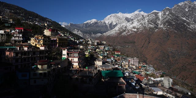 The town of Joshimath, India, is seen alongside snow-capped mountains on Jan. 21, 2023. For months, residents in Joshimath have seen their homes slowly sink. 