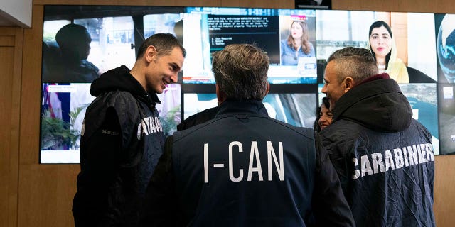 Italian carabinieri and police officers tasked against the 'ndrangheta talk at the Interpol headquarters in Lyon, France, on Feb.2, 2023.