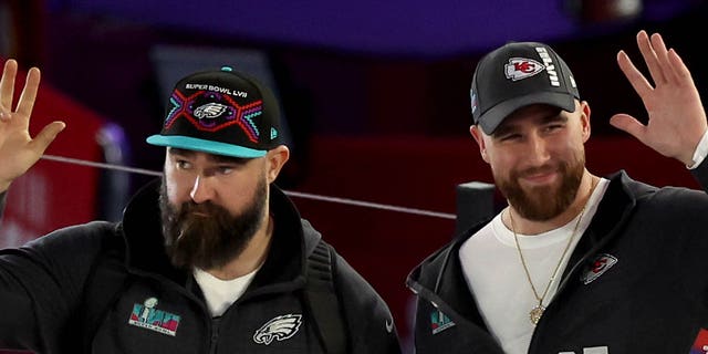 (L) Brothers Jason Kelce #62 of the Philadelphia Eagles and Travis Kelce #87 of the Kansas City Chiefs wave onstage during opening night of Super Bowl LVII presented by Fast Twitch at Footprint Center on February 6, 2023 in Phoenix, Arizona.