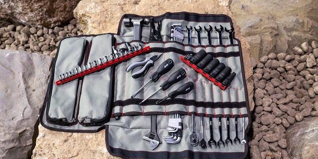 An 83-piece tool kit and custom canvas bag are included.
