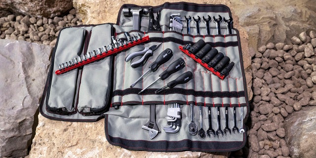 An 83-piece tool kit and custom canvas bag are included.